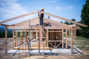 Hank Zarihs Associates | Builders working on wooden construction site, modern wooden house.